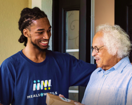 Volunteer delivering meal