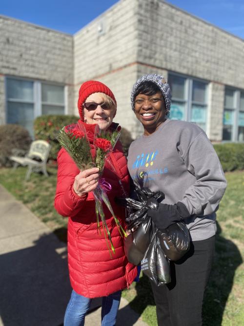 Volunteers are all smiles as they get ready to deliver donated bouqets from Mission Flowers.