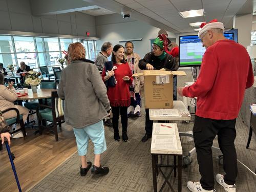 Wake County Medical Alliance passes out the gifts they donated to our Capital Towers Friendship Cafe Holiday Party guests!